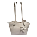 Sheonn beige pebble-textured faux leather tote bag with long shoulder straps and a playful dog-shaped charm.