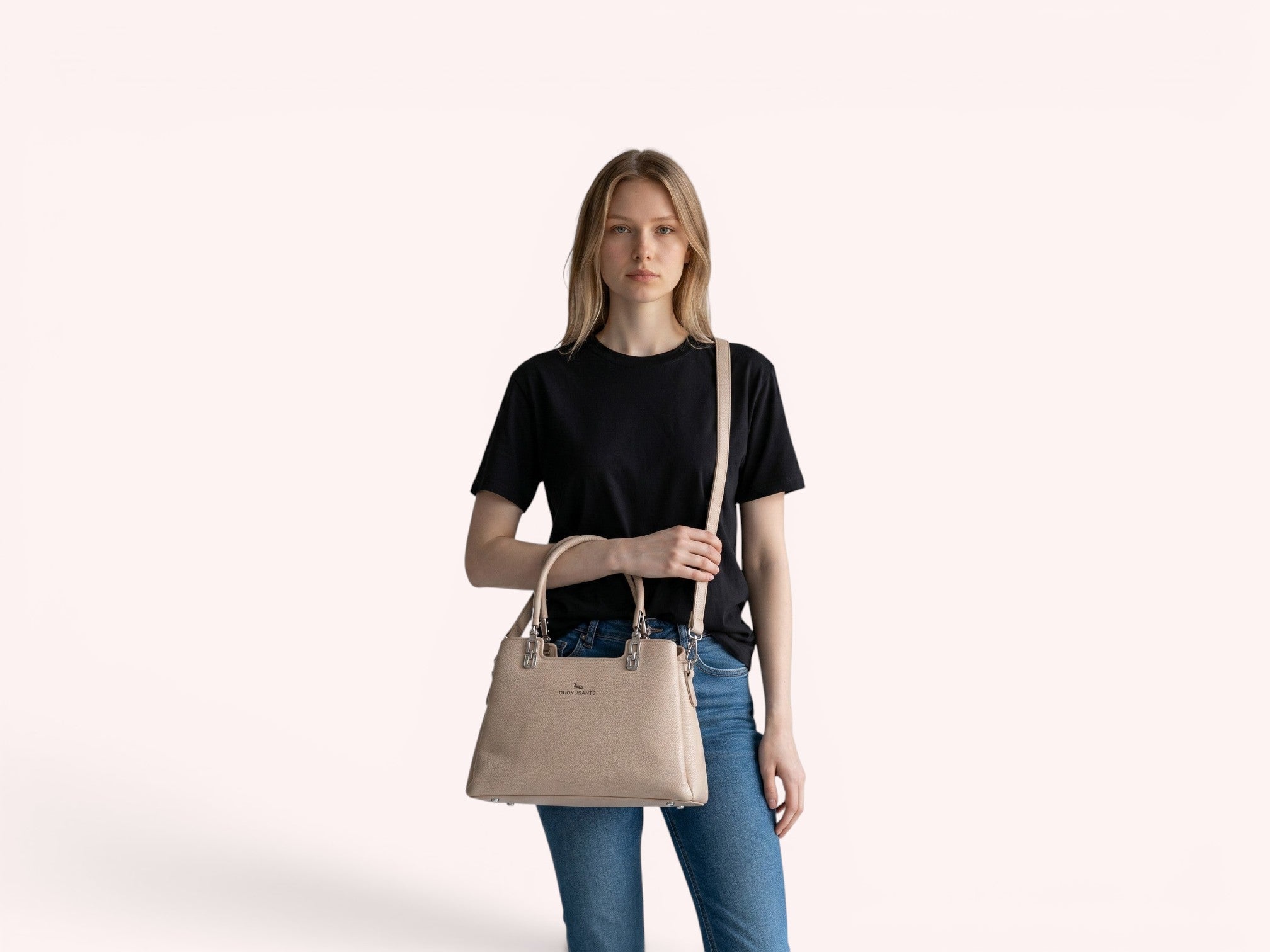 Model wearing a Sheonn beige textured faux leather DUOYU&ANTS structured handbag with silver hardware and shoulder strap
