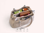 Sheonn beige faux leather structured handbag with multiple interior compartments filled with daily essentials.