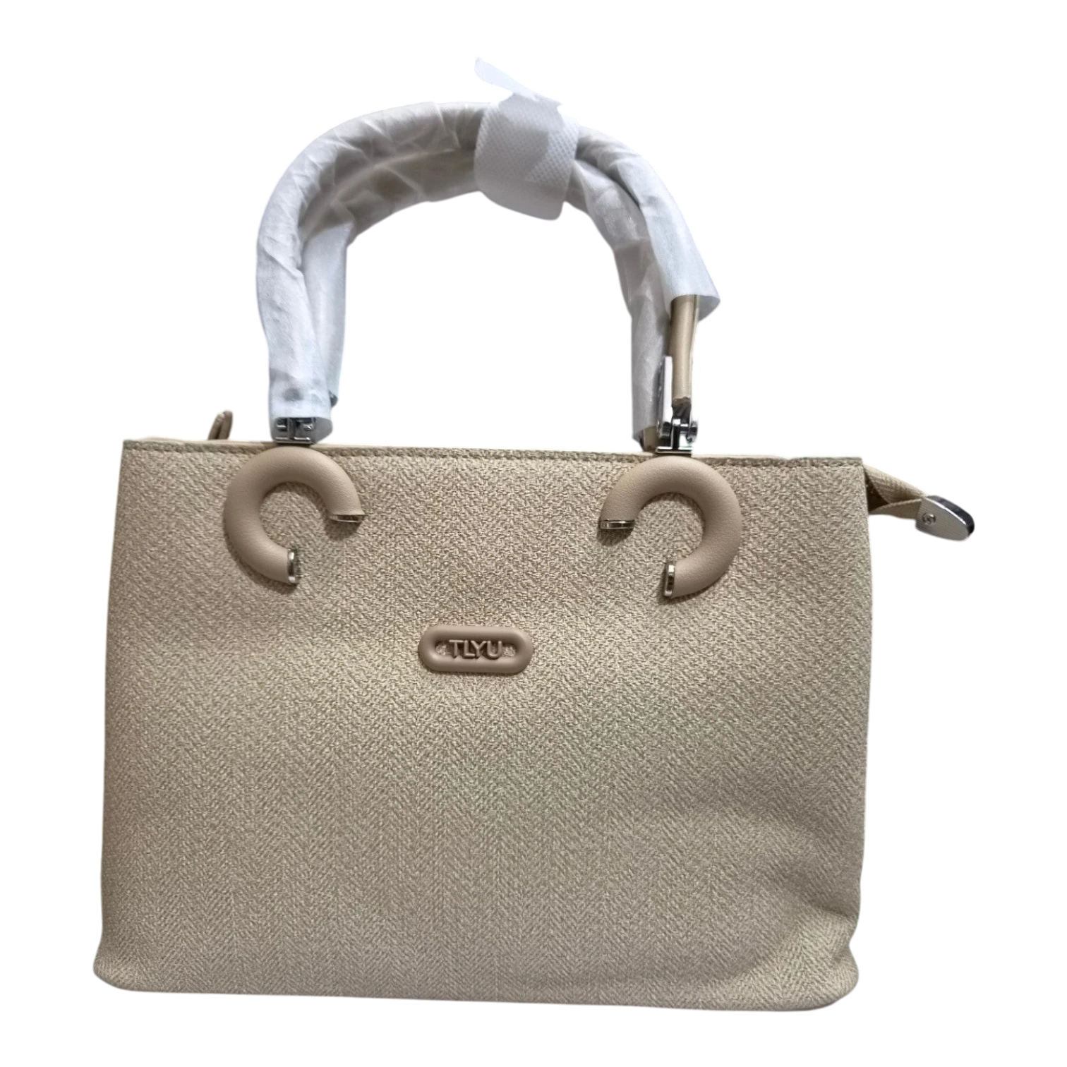 Sheonn beige structured handbag with textured finish, circular handle accents, and TLYU logo plate.