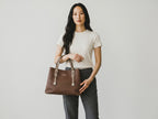 Model holding a brown Sheonn faux leather structured tote bag with pebbled texture and silver hardware details.