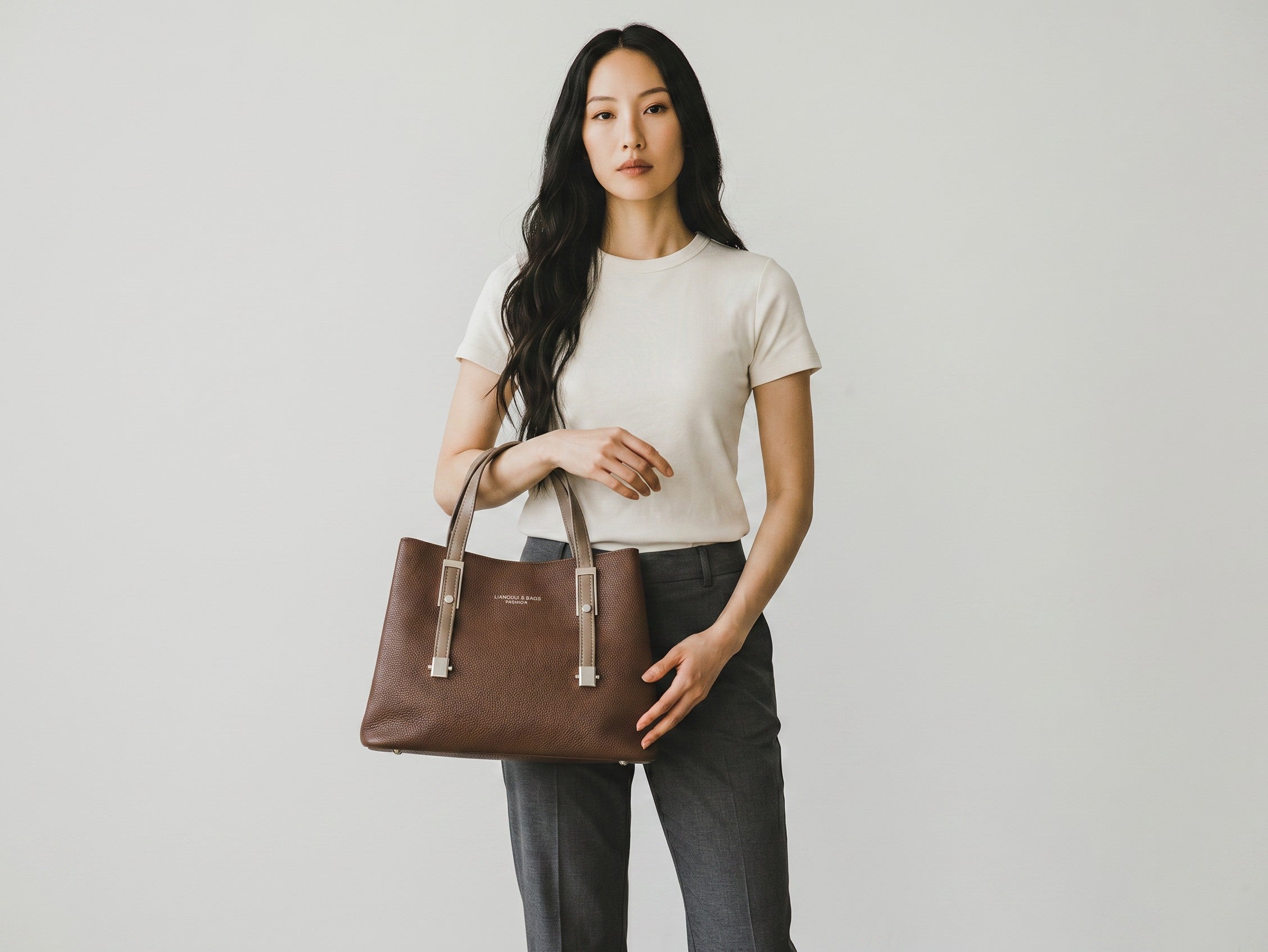 Model holding a brown Sheonn faux leather structured tote bag with pebbled texture and silver hardware details.