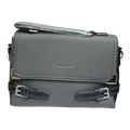 Sheonn grey textured satchel handbag with black faux-leather trim, silver hardware, and decorative buckle straps.