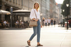 Woman wearing a Sheonn tan patterned structured handbag with a shoulder strap while walking on a city street.