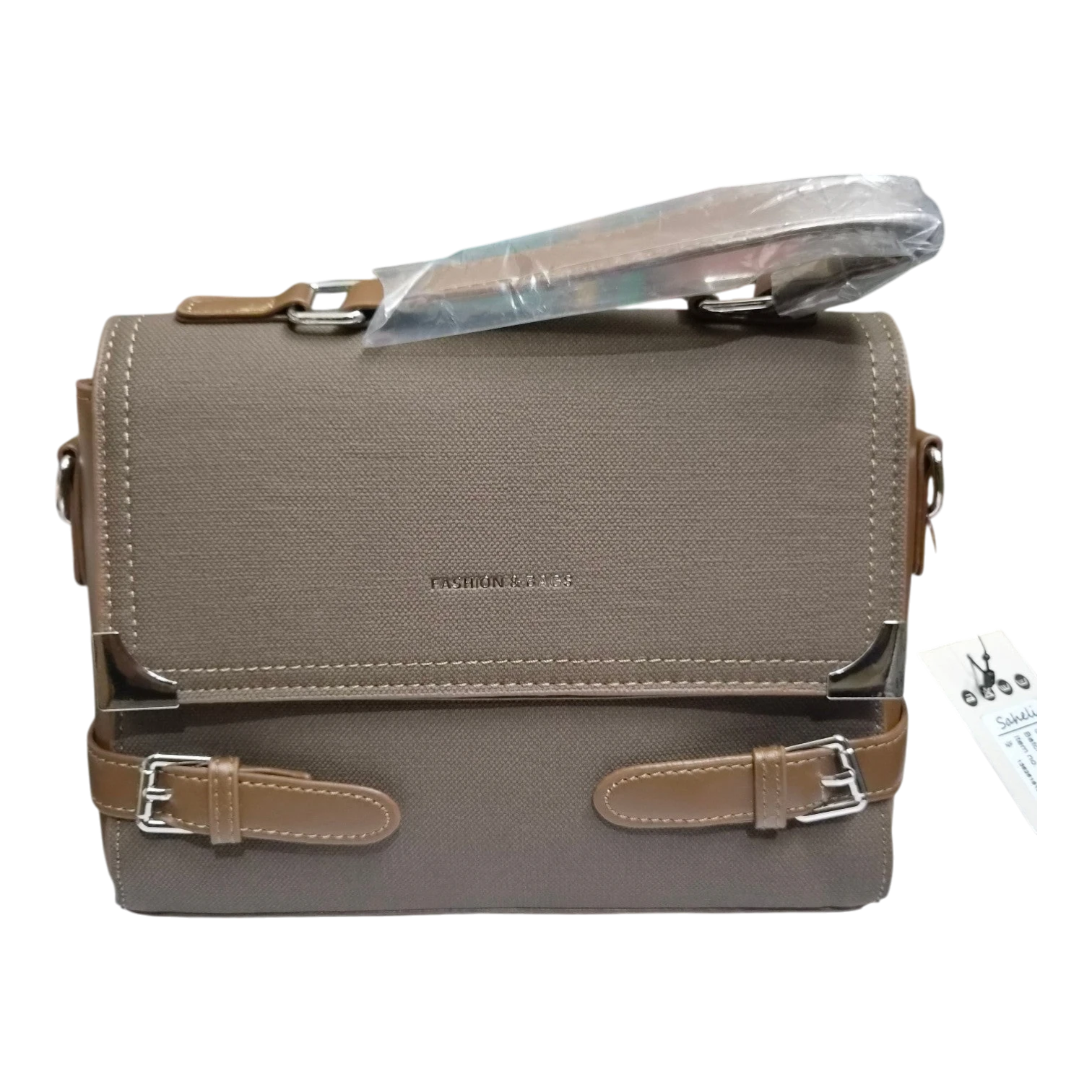 Sheonn taupe canvas satchel handbag with faux-leather buckle details, silver-tone hardware, and top handle.