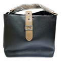 Sheonn black textured faux leather bucket handbag with a tan center strap, silver D emblem, and top handle.